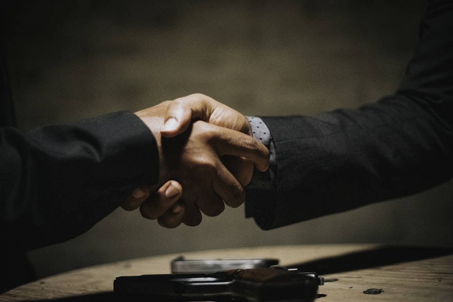 Business banking handshake at a desk