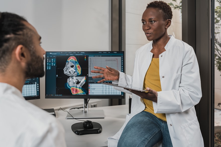 Clinicians reviewing patient flow data on diagnostic screens