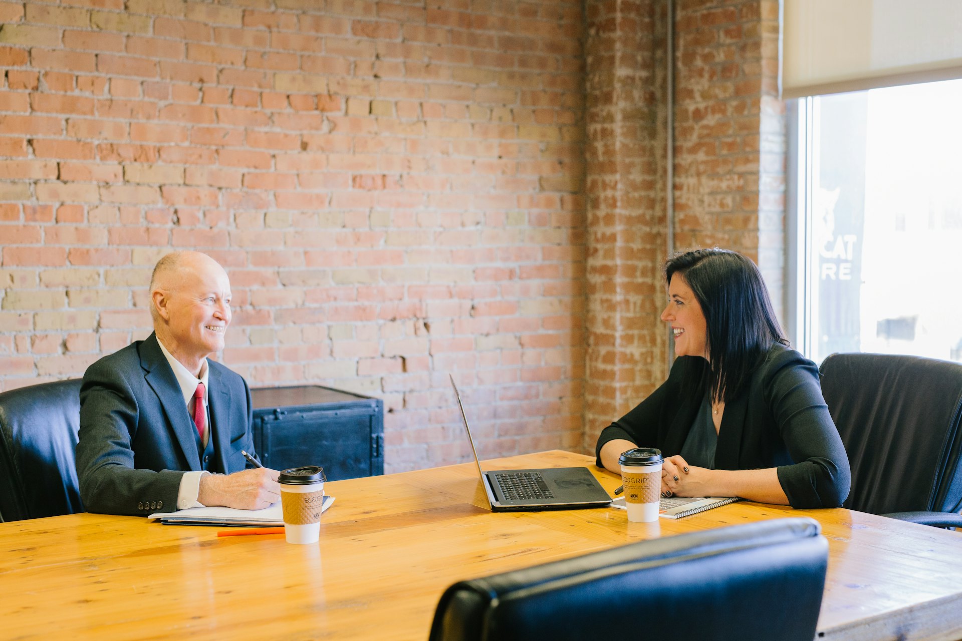 Financial advisor meeting a client at a desk