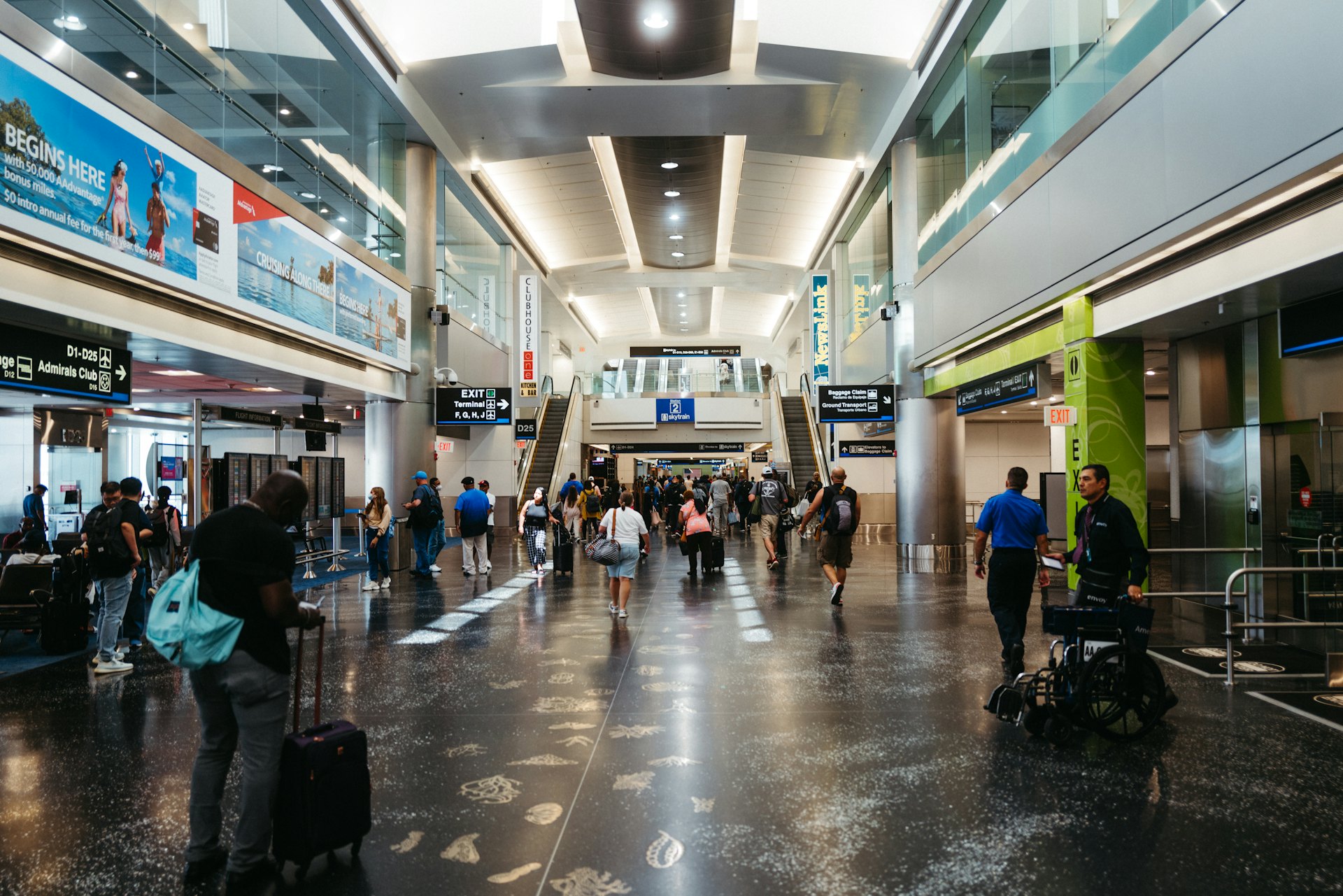Travelers moving through an airport terminal