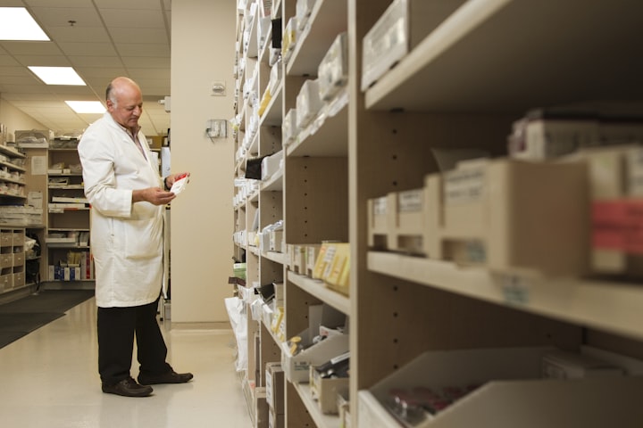 Pharmacist checking medication on pharmacy shelves