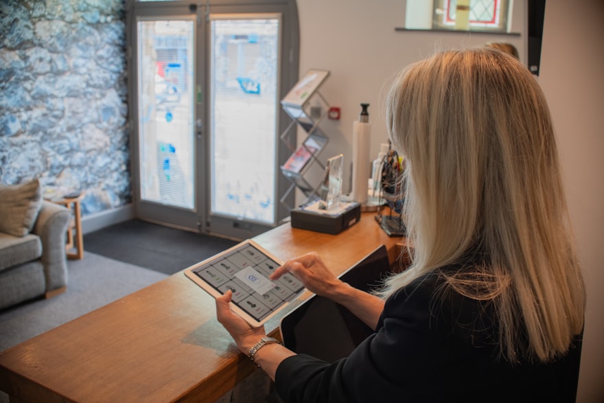 Visitor checking in on a tablet at a reception desk